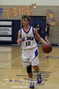 OB_Boys_vs_St_John_BB_2-21-12_0041 Kinser Crissman (#10) of the St. John Tigers looks for a teammate to pass the basketball to against the Otis-Bison Cougars at St. John High School in St. John, Kansas on February 21, 2012. Photo: Joey Bahr