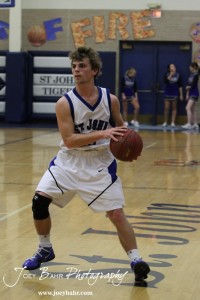 OB_Boys_vs_St_John_BB_2-21-12_0043 Kinser Crissman (#10) of the St. John Tigers looks for a teammate to pass the basketball to against the Otis-Bison Cougars at St. John High School in St. John, Kansas on February 21, 2012. Photo: Joey Bahr
