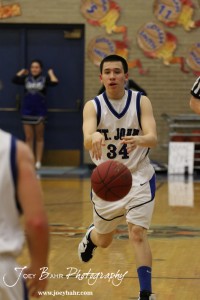 OB_Boys_vs_St_John_BB_2-21-12_0055 Zuriel Reyes (#34) of the St. John Tigers passes the basketball to a teammate against the Otis-Bison Cougars at St. John High School in St. John, Kansas on February 21, 2012. Photo: Joey Bahr