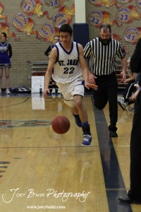 OB_Boys_vs_St_John_BB_2-21-12_0071 Esai Macias (#22) drives down the edge of the court against the Otis-Bison Cougars at St. John High School in St. John, Kansas on February 21, 2012. Photo: Joey Bahr