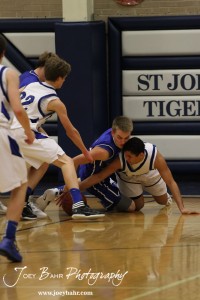 OB_Boys_vs_St_John_BB_2-21-12_0093 Otis-Bison Cougar Zachary Stejskal (#14) and St. John Tiger Spencer Nusser (#20) battle for the basketball at St. John High School in St. John, Kansas on February 21, 2012. Photo: Joey Bahr