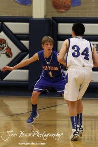 OB_Boys_vs_St_John_BB_2-21-12_0109 Justus Bartonek (#1) of the Otis-Bison Cougars watches St. John Tiger Zuriel Reyes (#34) at St. John High School in St. John, Kansas on February 21, 2012. Photo: Joey Bahr