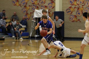 OB_Boys_vs_St_John_BB_2-21-12_0135 Patrick Piper (#22) of the Otis-Bison Cougars drives down court against the St. John Tigers at St. John High School in St. John, Kansas on February 21, 2012. Photo: Joey Bahr