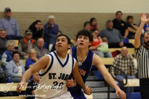 OB_Boys_vs_St_John_BB_2-21-12_0150 St. John Tiger Spencer Nusser (#20) and Otis-Bison Cougar Brandon Pechanec (#44) watch the basketball during a free throw attempt at St. John High School in St. John, Kansas on February 21, 2012. Photo: Joey Bahr
