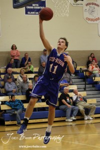 OB_Boys_vs_St_John_BB_2-21-12_0169 Dylan Wissman (#11) of the Otis-Bison Cougars goes up for a layup against the St. John Tigers at St. John High School in St. John, Kansas on February 21, 2012. Photo: Joey Bahr