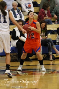 Annie Kraisinger (#12) of the Otis-Bison Lady Cougars looks to pass the basketball agains the St. John Lady Tigers at St. John High School in St. John, Kansas on February 21, 2012.  Photo: Joey Bahr