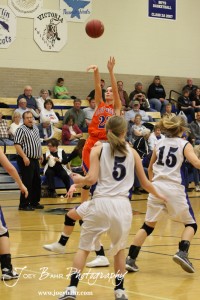 Otis-Bison Lady Cougar Hannah Bannister (#23) takes a shot over the St. John Lady Tigers defense at St. John High School in St. John, Kansas on February 21, 2012.  Photo: Joey Bahr