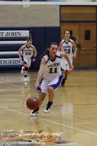 Morgan Osborne (#11) drives down the court with the basketball against the Otis-Bison Lady Cougars at St. John High School in St. John, Kansas on February 21, 2012.  Photo: Joey Bahr