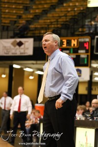 Otis-Bison Cougars Head Coach Alan Clark communicates to his players against the Greeley County Jackrabbits in the 2012 Class 1A Division II Boys State Championship Quarterfinals Game at Gross Memorial Coliseum at Fort Hays State University in Hays, Kansas on March 7, 2012.  Photo: Joey Bahr
