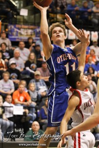 Dylan Wissman (#11) of the Otis-Bison Cougars goes up for a shot against the Greeley County Jackrabbits in the 2012 Class 1A Division II Boys State Championship Quarterfinals Game at Gross Memorial Coliseum at Fort Hays State University in Hays, Kansas on March 7, 2012.  Photo: Joey Bahr