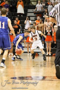 2012 Class 1A Division II Boys State Championship Semifinals Trevor Keller (#3) of the Otis-Bison Cougars dribbles towards Hope Lion Nathan Lorson (#3) in the 2012 Class 1A Division II Boys State Championship Semifinals Game at Gross Memorial Coliseum at Fort Hays State University in Hays, Kansas on March 9, 2012. Photo: Joey Bahr