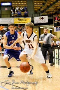 2012 Class 1A Division II Boys State Championship Semifinals Hope Lion Landon Cook (#11) dribbles around Otis-Bison Cougar Trevor Keller (#3) in the 2012 Class 1A Division II Boys State Championship Semifinals Game at Gross Memorial Coliseum at Fort Hays State University in Hays, Kansas on March 9, 2012. Photo: Joey Bahr
