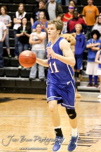 2012 Class 1A Division II Boys State Championship Semifinals Dylan Wissman (#11) of the Otis-Bison Cougars carries the basketball down the court against the Hope Lions in the 2012 Class 1A Division II Boys State Championship Semifinals Game at Gross Memorial Coliseum at Fort Hays State University in Hays, Kansas on March 9, 2012. Photo: Joey Bahr