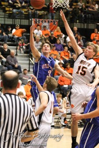 2012 Class 1A Division II Boys State Championship Semifinals Trevor Keller (#3) of the Otis-Bison Cougars tries to lay the basketball in while Hope Lion Phillip Haslouer (#15) goes for the block in the 2012 Class 1A Division II Boys State Championship Semifinals Game at Gross Memorial Coliseum at Fort Hays State University in Hays, Kansas on March 9, 2012. Photo: Joey Bahr