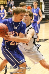 2012 Class 1A Division II Boys State Championship Semifinals Otis-Bison Cougar Patrick Piper (#22) tries to keep the ball away from Hope Lion defender Dwight Davidson (#31) in the 2012 Class 1A Division II Boys State Championship Semifinals Game at Gross Memorial Coliseum at Fort Hays State University in Hays, Kansas on March 9, 2012. Photo: Joey Bahr