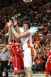 Abilene Cowboy Chad Beetch (#20) goes up for a shot against the defense of Fort Scott Tiger Cameron Woodring (#24) in the 2012 Class 4A Boys State Championship Quarterfinals Game at Salina Bicentennial Center in Salina, Kansas on March 8, 2012.  Photo: Joey Bahr