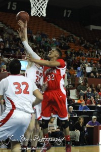 Travell Robinson (#32) of the McPherson Bullpups has his shot deflected by Ottawa Cyclone Wyatt Peters (#24) in the 2012 Class 4A Boys State Championship Quarterfinals Game at Salina Bicentennial Center in Salina, Kansas on March 8, 2012.  Photo: Joey Bahr