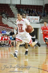 Dallas Natt (#22) of the Ottawa Cyclones drives down the court against the McPherson Bullpups in the 2012 Class 4A Boys State Championship Quarterfinals Game at Salina Bicentennial Center in Salina, Kansas on March 8, 2012.  Photo: Joey Bahr