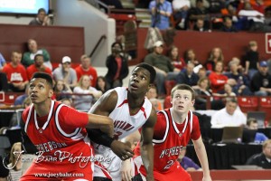 McPherson Bullpups Travell Robinson (#32) and Kyler Kinnamon (#22) and Ottawa Cyclone Semi Ojeleye (#33) watch a free throw attempt in the 2012 Class 4A Boys State Championship Quarterfinals Game at Salina Bicentennial Center in Salina, Kansas on March 8, 2012.  Photo: Joey Bahr