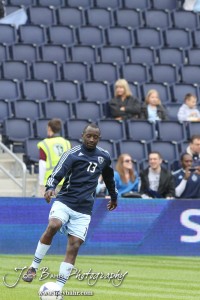 Sporting_KC_vs_LA_Galaxy_4-7-12_0401 Defender Lawrence Olum (#13) of Sporting Kansas City warms up before the match with LA Galaxy at LIVESTRONG Sporting Park in Kansas City, Kansas on April 7, 2012. (Photo: Joey Bahr, www.joeybahr.com)