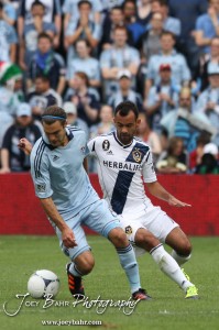 Sporting_KC_vs_LA_Galaxy_4-7-12_0553 Sporting Kansas City Midfielder Graham Zusi (#8) plays the ball around an LA Galaxy defender at LIVESTRONG Sporting Park in Kansas City, Kansas on April 7, 2012. (Photo: Joey Bahr, www.joeybahr.com)