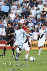 Sporting_KC_vs_LA_Galaxy_4-7-12_0554 Sporting Kansas City Defender Julio Cesar (#55) kicks the ball away from LA Galaxy Midfielder Michael Stephens (#26) at LIVESTRONG Sporting Park in Kansas City, Kansas on April 7, 2012. (Photo: Joey Bahr, www.joeybahr.com)