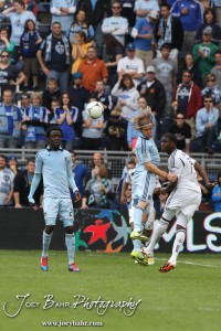 Sporting_KC_vs_LA_Galaxy_4-7-12_0666 Defender Chance Myers (#7) of Sporting Kansas City heads the ball away from LA Galaxy Forward Edson Buddle (#14) at LIVESTRONG Sporting Park in Kansas City, Kansas on April 7, 2012. (Photo: Joey Bahr, www.joeybahr.com)