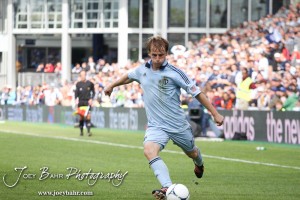 Sporting_KC_vs_LA_Galaxy_4-7-12_0918 Sporting Kansas City Defender Seth Sinovic (#16) kicks the ball against LA Galaxy at LIVESTRONG Sporting Park in Kansas City, Kansas on April 7, 2012. (Photo: Joey Bahr, www.joeybahr.com)