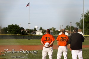 KSHSAA 4A Regional Baseball Championship The coaches for the Colby Eagles watch the American Flag during the National Anthem before their game against the Nickerson Panthers at the KSHSAA 4A Regional Baseball Championship at Legion Field in Hoisington, Kansas on May 16, 2012. (Photo: Joey Bahr, www.joeybahr.com)