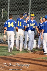KSHSAA 4A Regional Baseball Championship Nickerson Panthers teammates congratulate Quintin Crandall (#11) for scoring against the Colby Eagles at the KSHSAA 4A Regional Baseball Championship at Legion Field in Hoisington, Kansas on May 16, 2012. (Photo: Joey Bahr, www.joeybahr.com)