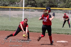 Great Bend Lady Panther McKenna Mauler (#22) runs to second as Liberal Lady Redskin Cynthia Cisneros (#5) fields the ball during the Liberal Lady Redskins at Great Bend Lady Panthers Softball Double Header with Great Bend winning both games 18-0 (3 innings) 13-0 at Barton Community College Softball Field in Great Bend, Kansas on April 27, 2013. (Photo: Joey Bahr, www.joeybahr.com)