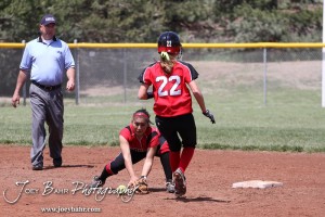 Liberal Lady Redskin Cynthia Cisneros (#5) tries to field the ball as Great Bend Lady Panther McKenna Mauler runs to Second during the Liberal Lady Redskins at Great Bend Lady Panthers Softball Double Header with Great Bend winning both games 18-0 (3 innings) 13-0 at Barton Community College Softball Field in Great Bend, Kansas on April 27, 2013. (Photo: Joey Bahr, www.joeybahr.com)