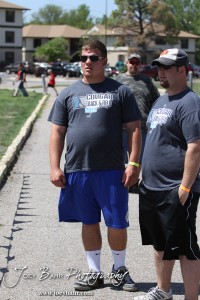 Otis-Bison Cougar Sam Higgason talks with his coach during the 2013 KSHSAA Class 1A Regional Track and Field competition at Lewis Field on the campus of Fort Hays State University in Hays, Kansas on May 17, 2013. (Photo: Joey Bahr, www.joeybahr.com)