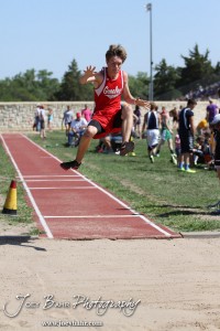 A Greeley County competitor reaches for more altitude in the long jump during the 2013 KSHSAA Class 1A Regional Track and Field competition at Lewis Field on the campus of Fort Hays State University in Hays, Kansas on May 17, 2013. (Photo: Joey Bahr, www.joeybahr.com)
