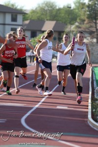 Batons are exchanged in the girls 4x800 Meter Relay during the 2013 KSHSAA Class 1A Regional Track and Field competition at Lewis Field on the campus of Fort Hays State University in Hays, Kansas on May 17, 2013. (Photo: Joey Bahr, www.joeybahr.com)