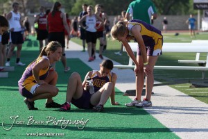 Two Trego Community High School runners comfort a fellow member of the 4x800 Meter Relay team during the 2013 KSHSAA Class 1A Regional Track and Field competition at Lewis Field on the campus of Fort Hays State University in Hays, Kansas on May 17, 2013. (Photo: Joey Bahr, www.joeybahr.com)