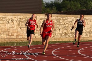 Girls turn the second corner in the first leg of the 4x100 Meter Relay during the 2013 KSHSAA Class 1A Regional Track and Field competition at Lewis Field on the campus of Fort Hays State University in Hays, Kansas on May 17, 2013. (Photo: Joey Bahr, www.joeybahr.com)