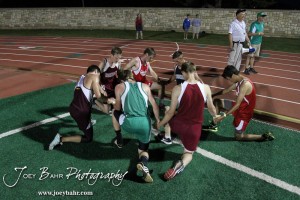 Runners from the Boys 3200 Meter Run gather to pray after the race during the 2013 KSHSAA Class 1A Regional Track and Field competition at Lewis Field on the campus of Fort Hays State University in Hays, Kansas on May 17, 2013. (Photo: Joey Bahr, www.joeybahr.com)