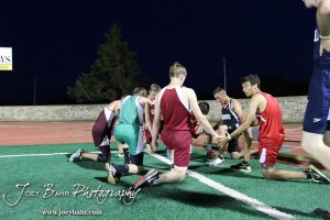 Runners from the Boys 3200 Meter Run gather to pray after the race during the 2013 KSHSAA Class 1A Regional Track and Field competition at Lewis Field on the campus of Fort Hays State University in Hays, Kansas on May 17, 2013. (Photo: Joey Bahr, www.joeybahr.com)